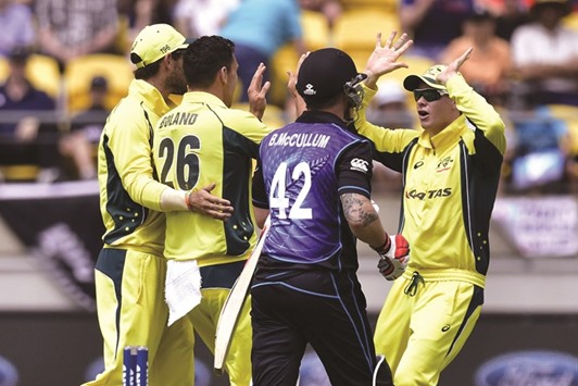 Steve Smith (R) of Australia celebrates with teammates after Brendon McCullum (C) of New Zealand was bowled during the 2nd one-day international cricket at Westpac Stadium in Wellington.
