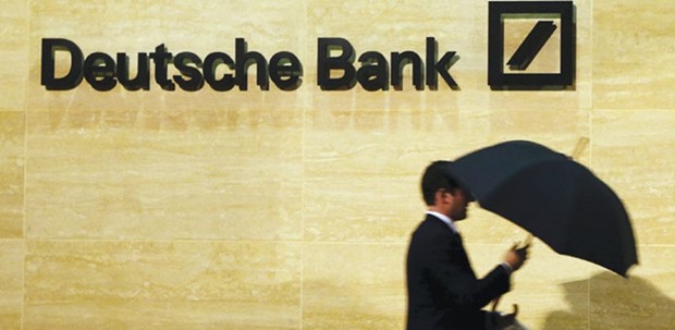 A man walks past Deutsche Bank office in London. Germanyu2019s biggest lender yesterday said it is financially u2018rock solidu2019 and has more-than-sufficient means to pay coupons on its riskiest debt both this year and next year.