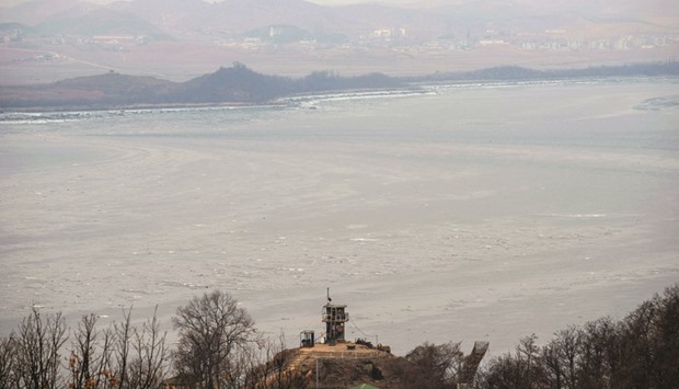 A South Korea military post, bottom centre,  before Demilitarised Zone (DMZ) and the North Korean shore-line, seen from Paju. Global concerns over North Koreau2019s latest nuclear test and long-range rocket launch have shone a spotlight on the perennial, high-tech game of hide-and-seek played around Pyongyangu2019s advanced weapons programmes. PICTURE: AFP/Ed Jones