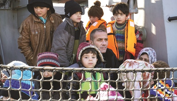 Migrants  arriving aboard a Hellenic coast guard ship at the Greek island of Lesbos.