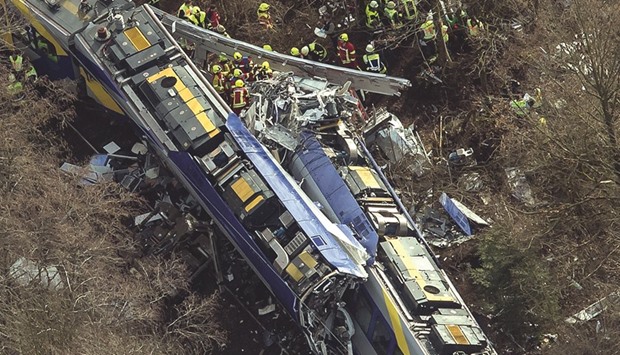 Firefighters and emergency doctors work at the site of the train crash near Bad Aibling.