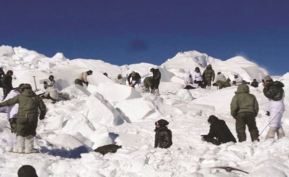 Army personnel search for survivors after a deadly avalanche on the Siachen glacier.