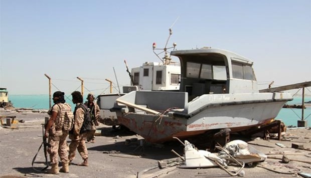 Pro-government forces walk in the port of the western Yemeni coastal town of Mokha.