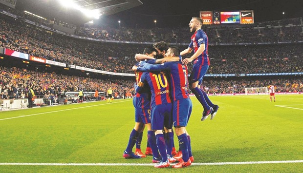 Barcelona players celebrate after Luis Suarez scored their first goal against Atletico Madrid during the Kingu2019s Cup semi-final second leg match at Camp Nou in Barcelona on Tuesday. (Reuters)