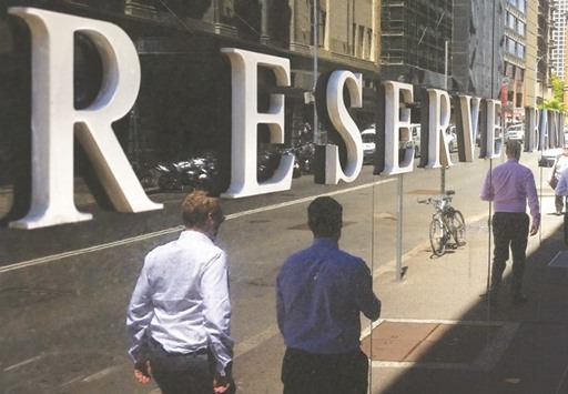 Pedestrians walk past the Reserve Bank of Australia building in Sydney. The RBA slashed the growth figures for the year ending June 2017 by one percentage point to 1.5%-2.5% following a 0.5% contraction in the third-quarter of last year.
