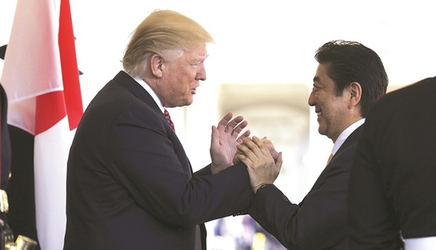 Abe is greeted by Trump ahead of their meeting and joint news conference at the White House.