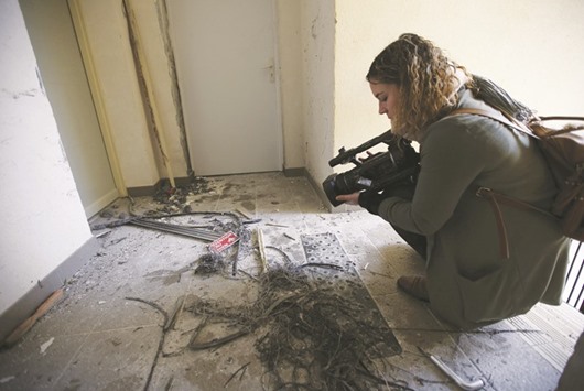 A journalist films the debris of an explosion at an apartment building following a raid by French police in Clapiers, near Montpellier. Four people were arrested in and around the southern French city of Montpellier on suspicion of planning an imminent attack in France, the interior ministry said yesterday.