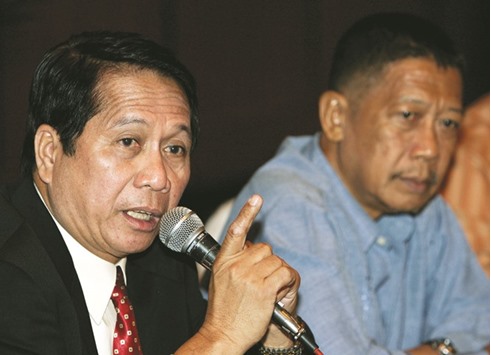 Secretary Jesus Dureza (left), Philippinesu2019 government peace advisor, speaks while professor Rudy Rodil, a member of the government panel negotiating with rebels, looks on during a news briefing in Manilau2019s Makati financial district.