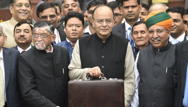 Indian Finance Minister Arun Jaitley (C) leaves his office to table the budget in Parliament in New Delhi.