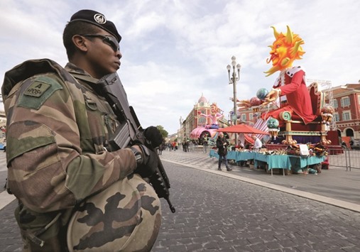 A French soldier stands guard before the start of the 133rd Nice carnival, the first major event since the city was attacked during Bastille Day celebrations last year.