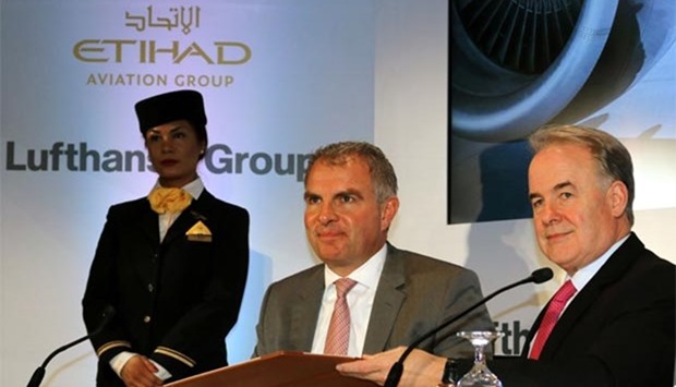 Carsten Spohr (C), Chief Executive Officer of Lufthansa, and Australian James Hogan, President and CEO of Etihad Aviation Group, speak during a press conference in Abu Dhabi on Wednesday.