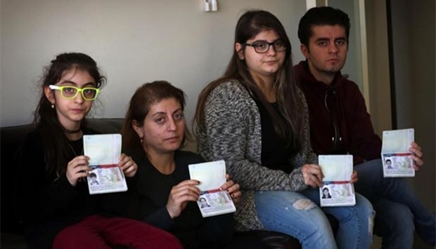 Fuad Sharef's family show their US immigrant visas in Arbil earlier this week.