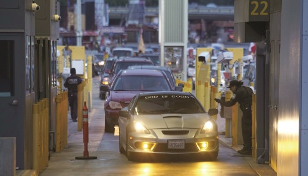 Customs and Border Protection agents check vehicles entering the United States at the San Ysidro Port of Entry in San Ysidro, California.