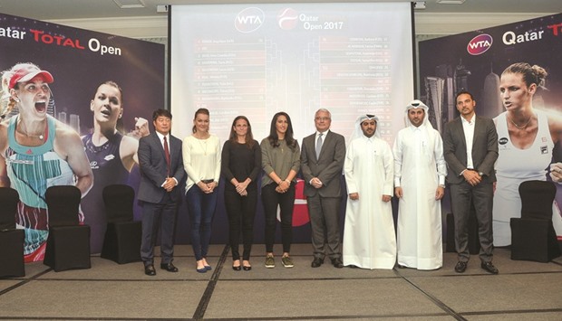 Tennis players and officials at the Qatar Total Open draw yesterday. At right, Caroline Wozniacki of Denmark.