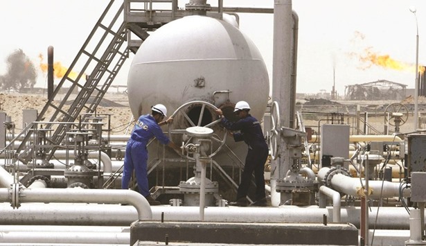 Workers of South Oil Company (SOC) adjust a valve at the Rumaila oil field in Basra Province in Iraq (file). Shipments from Opecu2019s second-largest producer fell to 3.805mn bpd in January from Decemberu2019s 4.03mn, tanker-tracking data and port agent reports showed, with the decline mainly reflecting a 6.5% drop in flows from the southern port of Basra.
