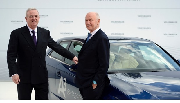 Volkswagen CEO Martin Winterkorn (L) and Chairman of the supervisory board of Volkswagen Ferdinand Piech posing at an Audi A3 electric car during a signing ceremony and a visit to the Volkswagen plant in Wolfsburg. April 23, 2012 file picture.