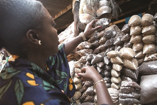 Essie Bartels buys spices at the Makola market in Accra.