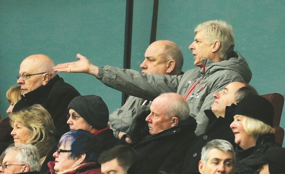 Arsenal manager Arsene Wenger (R) in the stands.