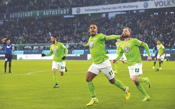 Daniel Didavi (C) of Wolfsburg celebrates after scoring his teamu2019s second goal yesterday.