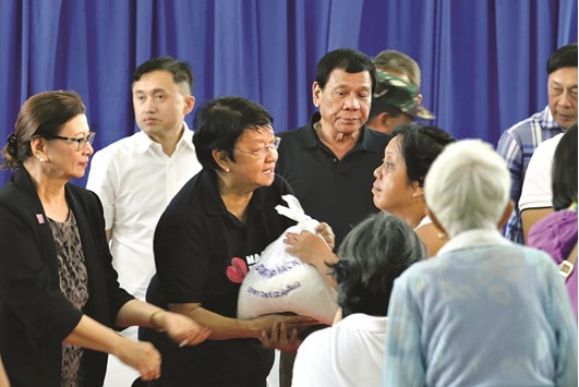 President Rodrigo Duterte, supervises the distribution of relief goods headed by social welfare Secretary Judy Taguiwalo (centre) to victims of the 6.5-magnitude earthquake in Surigao City.