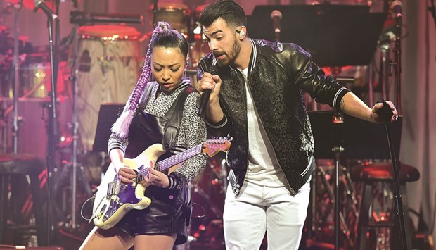 Singer Joe Jonas and JinJoo Lee of DNCE perform late on Saturday during the annual Clive Davis pre-Grammy gala at the Beverly Hilton.