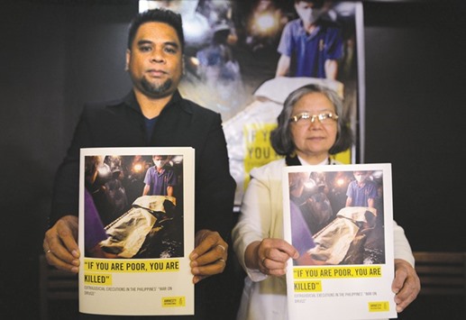 Wilnor Papa (left) and Sister Maria Cordero of Amnesty International Philippines, show copies of their report during a press conference in Manila yesterday.