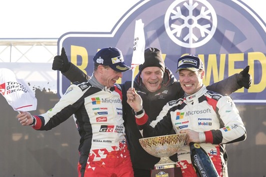 Jari Matti Latvala (right) and co-driver Miikka Anttila celebrate their win in Rally Sweden with team manager Tommi Makinen in Torsby, Sweden, yesterday. (AFP)