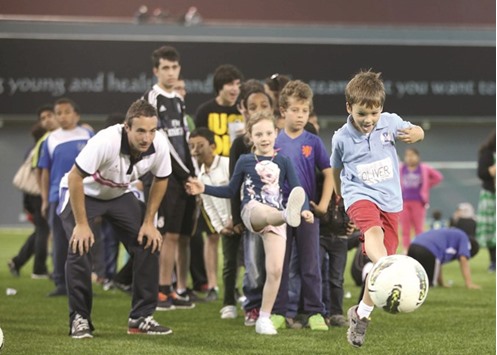Children play football at Aspire Zone during last yearu2019s National Sport Day.
