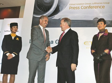 Carsten Spohr, chief executive officer of Lufthansa, and James Hogan, president and CEO of Etihad Aviation Group, shake hands following a press conference in Abu Dhabi yesterday. The long-time adversaries have concluded a $100mn agreement in global catering and signed a memorandum of understanding for cooperation in plane repair and overhaul.