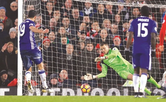 Liverpool goalkeeper Simon Mignolet saves a penalty off Chelseau2019s Diego Costa during the Premier League match at Anfield, Liverpool on Tuesday night. (Reuters)