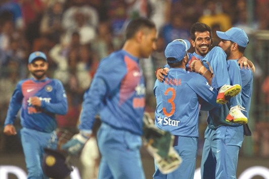 Indian bowler Yuzvendra Chahal (second from right) is lifted by teammates Suresh Raina and Yuvraj Singh for his six-wicket haul against England during the third Twenty20 International match in Bangalore yesterday. (AFP)