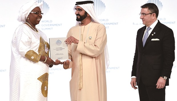 Sheikh Mohamed bin Rashid al-Maktoum, Vice-President and Prime Minister of the UAE and Ruler of Dubai, accompanied by George Atalla (right), Partner and Global Leader, Government and Public Sector at EY, presents the Best Ministeru2019s Award 2017 to Awa Marie Coll Seck, Senegalese Minister of Health and Social Action during the World Government Summit 2017, in Dubaiu2019s Madinat Jumeirah yesterday.