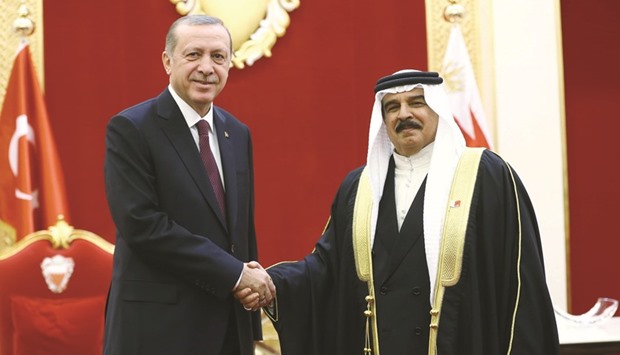 This handout photo taken and released by Turkeyu2019s Presidential Press Office yesterday in Manama shows King of Bahrain Hamad bin Isa al-Khalifah welcoming Turkish President Recep Tayyip Erdogan during his visit to Bahrain.