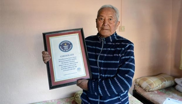 Nepalese mountaineer Min Bahadur Sherchan shows off his 2008 Guinness World Record certificate for being the oldest person to summit Mount Everest -- a record that was later broken in 2013.
