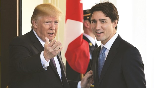 US President Donald Trump greets Canadau2019s Prime Minister Justin Trudeau outside the West Wing of the White House in Washington yesterday.