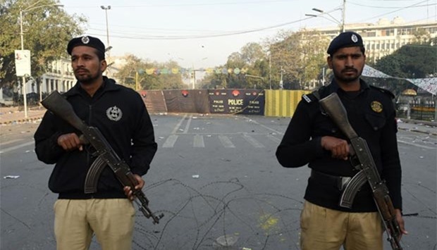 Police stand guard at the site of a suicide bombing in Lahore on Tuesday.