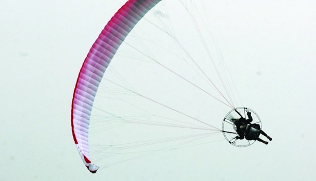 A paramotor pilot executes a maneuver during the Qatar Air Sport Committee's 'paratrooper show'. PICTURE: Shemeer Rasheed.