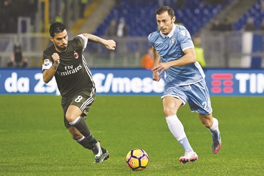 Lazio defender from Romania Stefan Radu (R) vies for the ball with AC Milanu2019s forward from Spain Fernandez Suso during their Italian Serie A match  at Romeu2019s Olympic stadium on Monday.