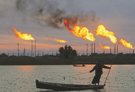 Flames emerge from flare stacks at the oil fields in Basra, Iraq on January 17. The International Energy Agency reported last Friday that Opec achieved the best compliance rate in its history at the outset of the accord.