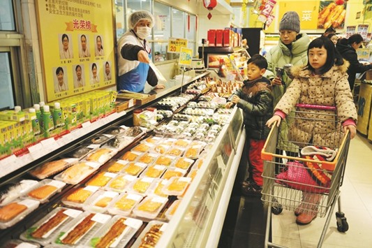 Chinese customers buy food at a supermarket in Qingdao, Shandong province. Prices for goods at the factory gate in China expanded for a fifth straight month, the government said yesterday, in a sign of strengthening demand as the worldu2019s second-largest economy stabilises.