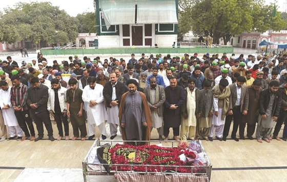 Pakistani relatives and residents offer funeral prayers for a blast victim during a ceremony in Lahore yesterday.