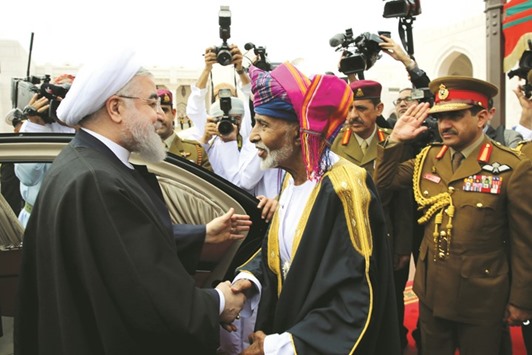Iranu2019s President Hassan Rouhani shakes hands with Omanu2019s Sultan Qaboos in Muscat yesterday.