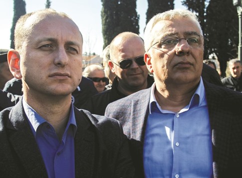 Opposition leaders Milan Knezevic (left) and Andrija Mandic wait for their immunity to be lifted in front of the Montenegrin parliament in Podgorica.