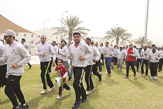 Qatar Steel employees and their families take to the jogging track.