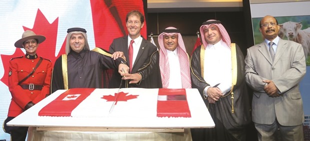 HE the Minister of Education and Higher Education Mohamed Abdul Wahed Ali al-Hammadi and Canadian ambassador Adrian Norfolk jointly cut a cake at Canadau2019s 150th Anniversary of Confederation celebration yesterday in Doha as other dignitaries look on. PICTURE: Jayan Orma