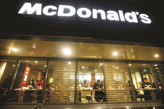 Customers eat dinner at a McDonaldu2019s store in Beijing. The American fast food giant said last month it had agreed to sell the bulk of its China and Hong Kong business to state-backed conglomerate CITIC and US private equity firm Carlyle Group for up to $2.1bn, in a deal that will see the consortium act as the master franchisee for a 20-year period.