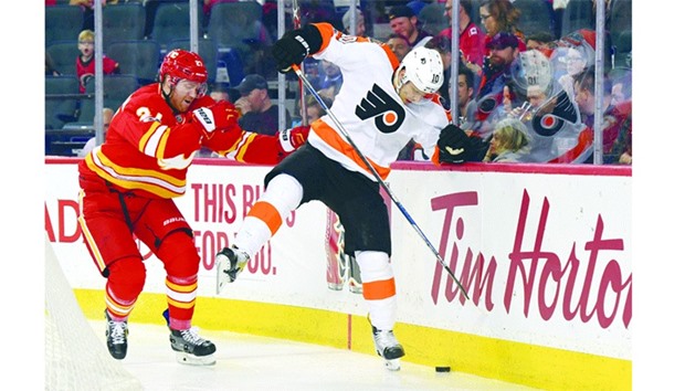 Calgary Flames defenseman Dougie Hamilton (27) collides with Philadelphia Flyers center Brayden Schenn (10) during the second period at Scotiabank Saddledome. PICTURE: Candice Ward-USA TODAY Sports