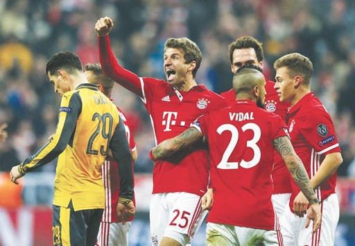 Bayern Munichu2019s Thomas Muller (second from left) celebrates his goal with teammates during their UEFA Champions League Round of 16 First Leg match against Arsenal at Allianz Arena in Munich, Germany, on Wednesday. (Reuters)