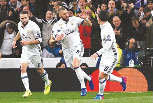 Benzema (centre) celebrates his goal against Napoli. (Reuters)