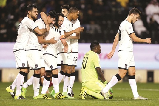 Baghdad Bouedjah is congratulated by his teammates, including Xavi, after one of his goals against Al Arabi yesterday.